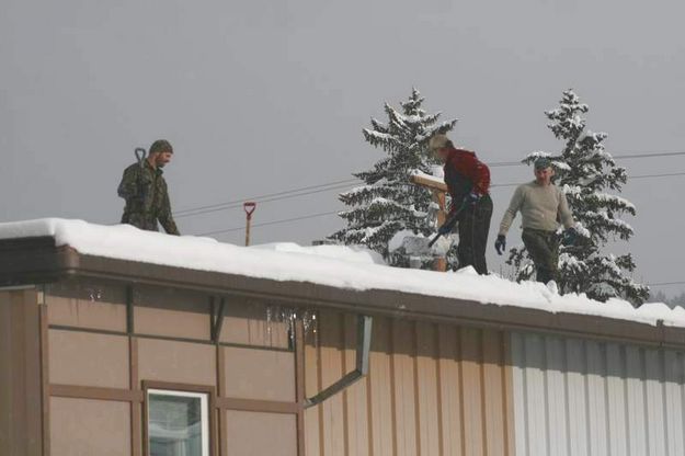 Shoveling a downtown roof. Photo by LibbyMT.com.