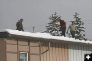 Shoveling a downtown roof. Photo by LibbyMT.com.