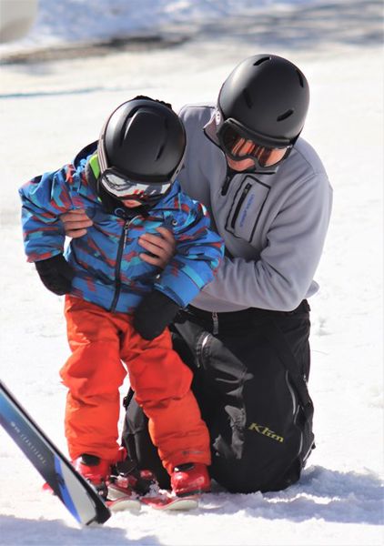Dad helps with the skis. Photo by LibbyMT.com.